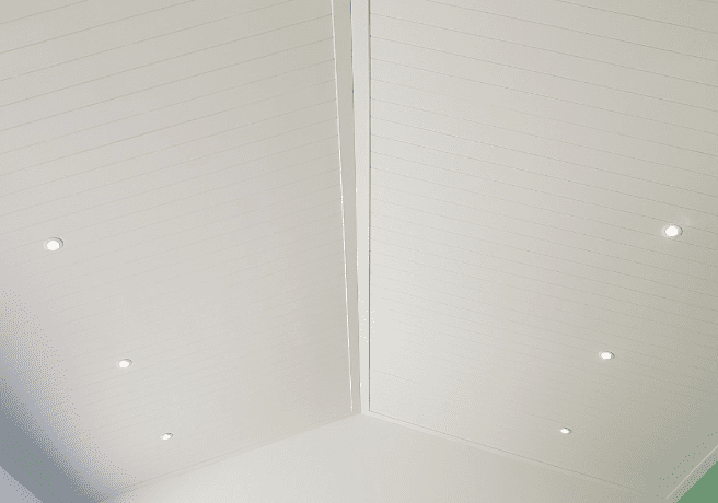 Fibre cement decorative facade board for ceiling applications