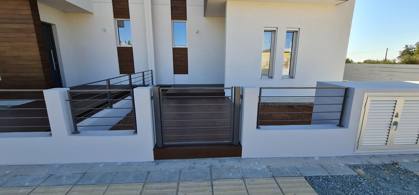 Seamless Stucco Exterior with Decorative Facade and Decking